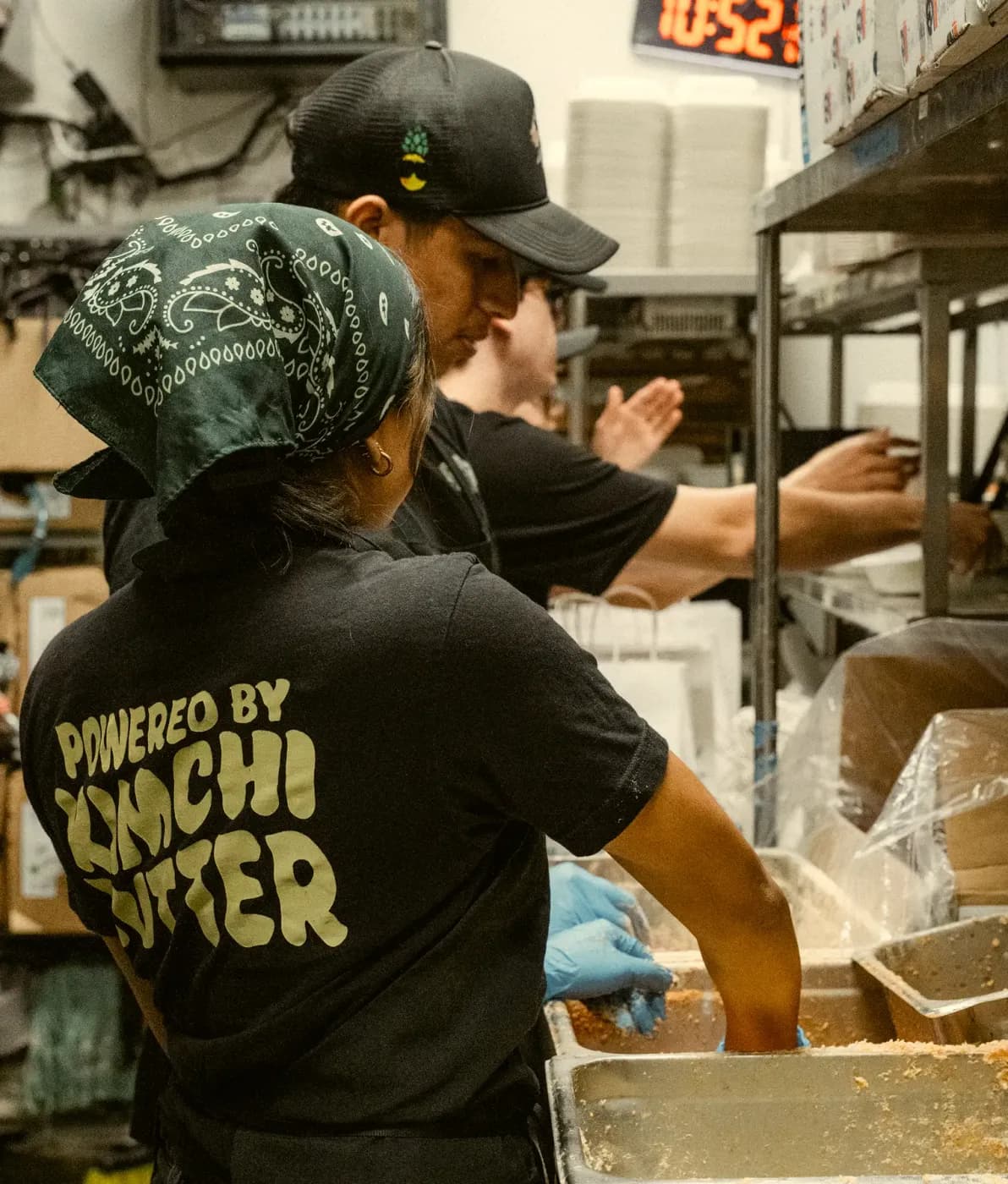 The kitchen crew working the line in Powered By Kimchi Butter shirts