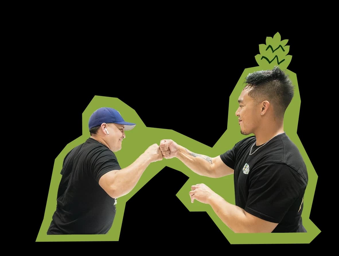 Two crew members sharing a fist bump